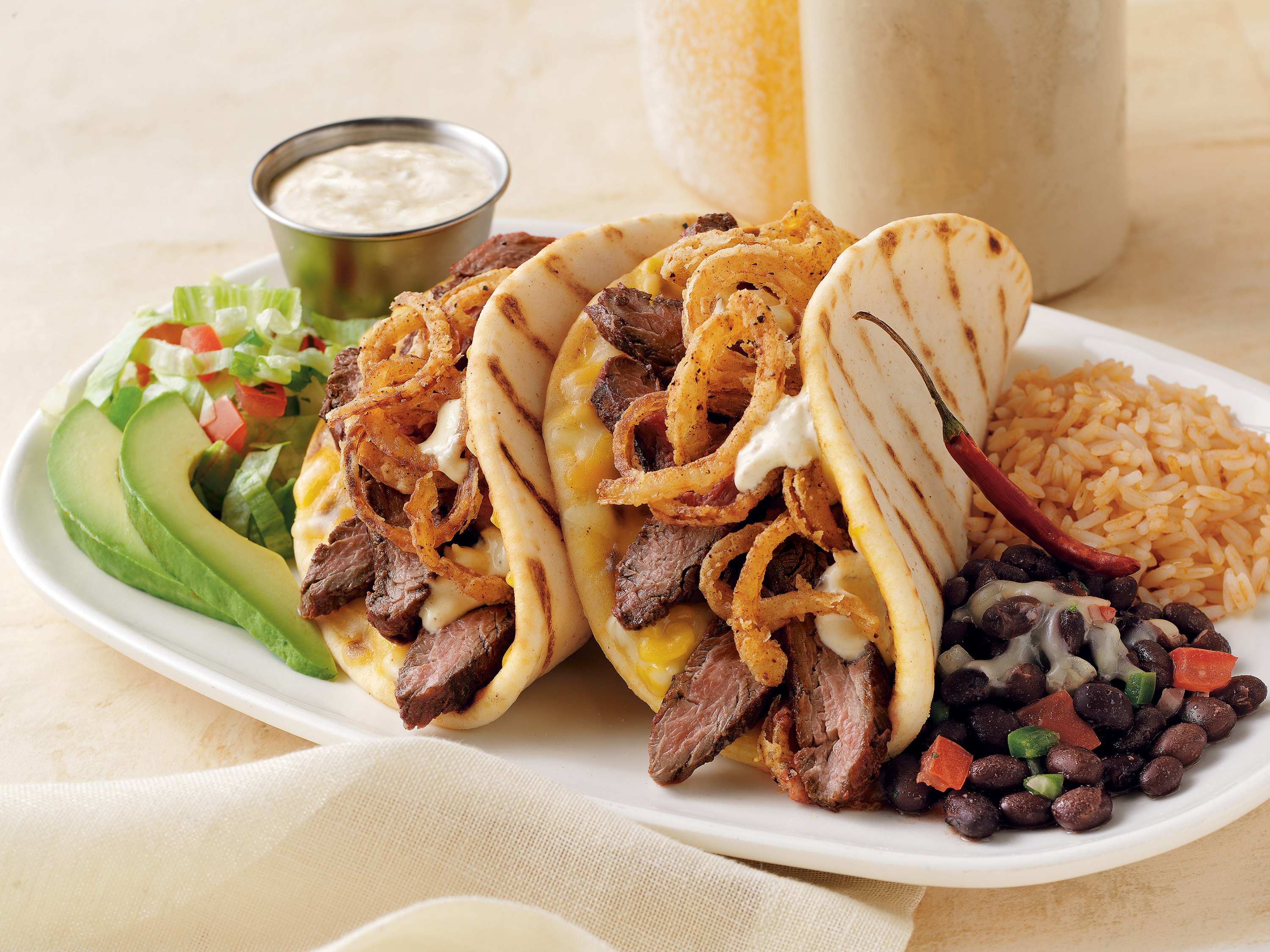 Meat corn taco with black beans and avocado